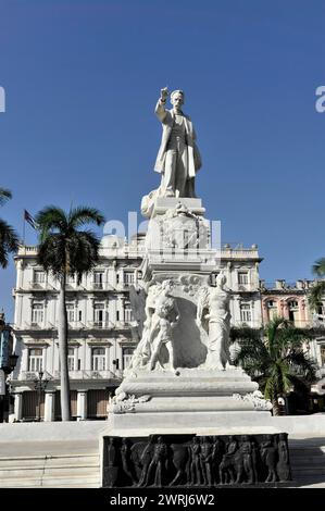 Scultura in marmo bianco di un monumento di fronte a un cielo limpido circondato da palme, l'Avana, Cuba, America centrale Foto Stock