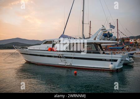 Molo degli yacht sulla riva del mare al tramonto. Impressionante tramonto estivo in Grecia. Emozionante serata sul Mar Egeo con molti yacht di lusso. Bellissimo paesaggio marino Foto Stock