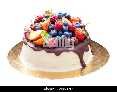 Deliziosa torta con frutta immersa nel cioccolato fuso, noci pecan, uva, bocconcini di cioccolato e biscotti. Concetto di torta di raccolta autunnale o estiva Foto Stock