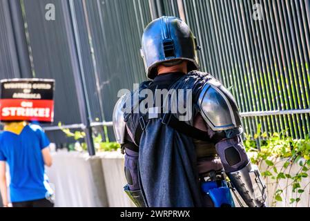 Un attore, Tim Brehmer, vestito come il personaggio di Star Wars, Mandalorian pattina sul marciapiede il 14 luglio 2023, all'Hollywood Strike. Credito: Erik Morgan Foto Stock