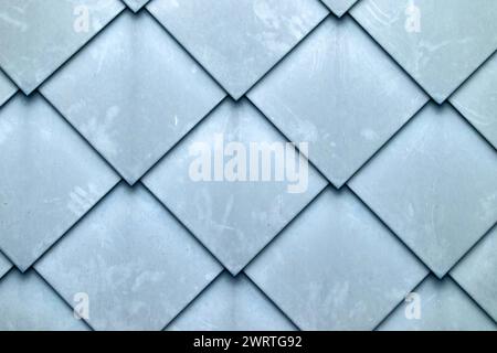 Fondo a scala di pesci a forma di diamante con struttura piastrellata della parete Foto Stock