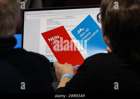 Glauchau, Germania. 14 marzo 2024. Un delegato dell'AfD ha in mano due carte di voto alla conferenza del partito di stato. Nei prossimi giorni, l'AfD sassone vuole stabilire la rotta del personale per le elezioni statali del 1° settembre in città. Dopo ripetuti incidenti, questa volta l'elenco degli stati deve essere redatto senza errori. L'AfD ha previsto quattro giorni per la procedura. Crediti: Jan Woitas/dpa/Alamy Live News Foto Stock