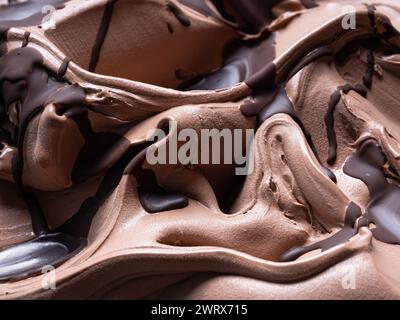 Gelato al cioccolato - dettaglio telaio completo. Primo piano di una superficie marrone di gelato al cioccolato ricoperto con una guarnizione di cioccolato fondente. Foto Stock