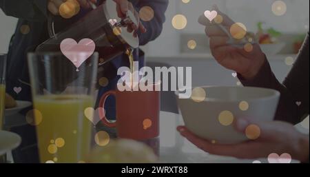 Immagine di cuori su una coppia caucasica che fa colazione Foto Stock