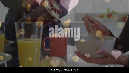 Immagine di cuori su una coppia caucasica che fa colazione Foto Stock