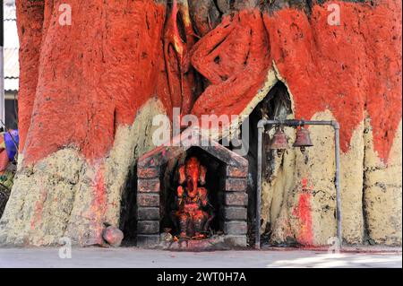 Colorata statua di Hanuman in una piccola nicchia religiosa su un muro rosso, Pokhara Valley, Pokhara, Nepal Foto Stock