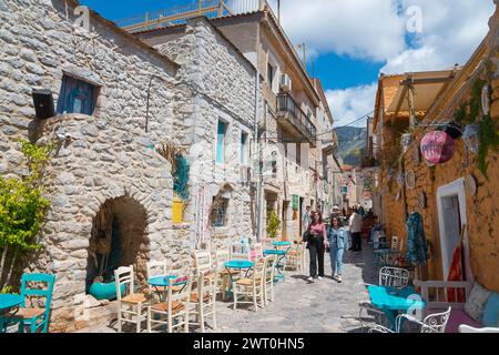 Vicolo affollato con ristoranti all'aperto ed edifici storici nel centro storico di Areopoli, Areopolis, Tsimova, Itylo, Anatoliki mani, mani, Laconia Foto Stock