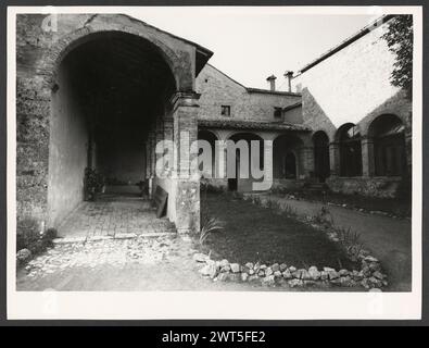 Umbria Terni Lugnano in Teverina S. Francesco. Hutzel, Max 1960-1990 vedute esterne di questa chiesa e chiostro del XIII secolo che fu il luogo di un miracolo di St Francesco (1212) include un campanile, dettagli dell'architettura medievale e un pozzo nel cortile. Le lunette del chiostro sono decorate con un ciclo di affreschi che ritraggono i miracoli di S.. Francesco (1616) di un ignoto maestro di Foligno. Le vedute interne della chiesa restaurata si concentrano sui dipinti dell'altare e gli altari in marmo dell'intarsia, alcuni dei quali mostrano anche scene della vita di San Francesco. Note oggetto: Hutz Foto Stock