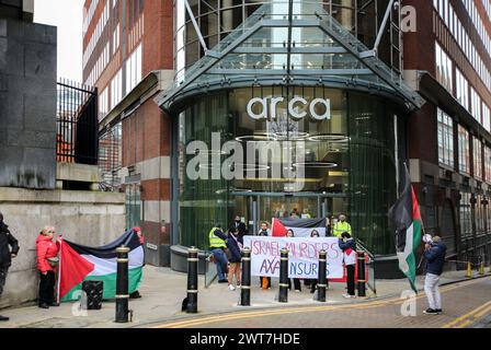 I manifestanti tengono uno striscione che dice gli omicidi di ëIsrael, AXA Insuresí e una bandiera palestinese fuori dagli uffici di AXAís durante la manifestazione. I manifestanti del fronte Giovanile per la Palestina (YFFP) e i loro sostenitori chiedono un boicottaggio dell'AXA, poiché affermano di investire oltre un miliardo di dollari in insediamenti illegali su quella che era una volta la terra palestinese e di tenere milioni in investimenti in tre banche israeliane. Affermano con questo sostegno finanziario che compagnie come AXA sono complici dei crimini di Israele contro i palestinesi a Gaza e altrove. Foto Stock