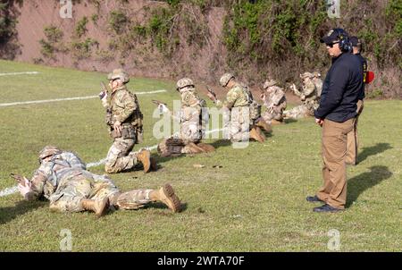 FORT MOORE, GA – I partecipanti al U.S. Army Small Arms Championships del 2024 affrontano obiettivi durante una partita di pistole a Parks Range, Fort Moore, Georgia, mentre i quadri assegnati alla U.S. Army marksmanship Unit (destra) guardano l'11 marzo 2024. La competizione annuale di tiro, comunemente nota come All Army, consente ai soldati di Active, Reserve, National Guard e ROTC Components di competere contro alcuni dei migliori tiratori dell'esercito durante l'impegnativo evento di più giorni. Foto Stock