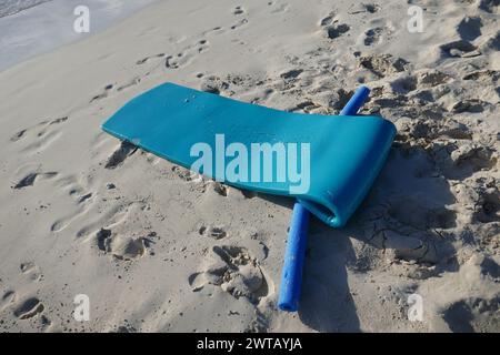 Vacanza in spiaggia tropicale con impronte di sabbia e oggetti ricreativi in spiaggia Foto Stock