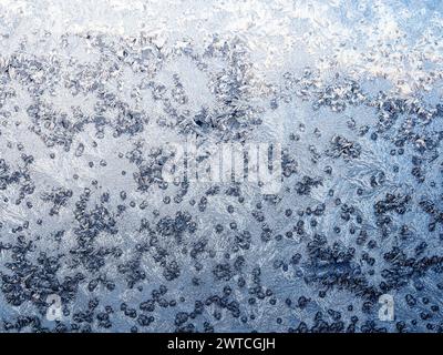 brina sul primo piano del vetro della finestra di casa al freddo crepuscolo invernale Foto Stock