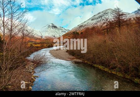 Le acque cristalline di Lingmell Beck, alla testa del lago Wastwater, si affacciano sulla vetta innevata del Great Gable in lontananza. Foto Stock