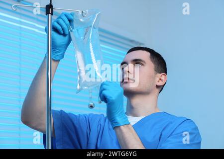 Infermiere che predispone l'infusione IV in ospedale Foto Stock