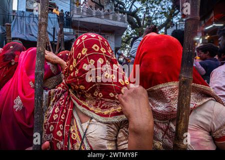 Mathura, Uttar Pradesh, India. 18 marzo 2024. Il calcio è celebrato a Barsana e Nandgaon dell'Uttar Pradesh, in India. Queste donne picchiano gli uomini con i bastoni, simboleggiando la risatina di Lord Krishna. Canzoni popolari, colori e dolci sono apprezzati durante il festival. Radha e il suo entourage si sono offesi per le sue avances e hanno cacciato Krishna dal villaggio. Ogni anno, gli uomini di Nandgaon viaggiano a Barsana, dove vengono accolti da donne che maneggiano lathis (bastoni), da cui il nome Lathmar Holi. Crediti: ZUMA Press, Inc./Alamy Live News Foto Stock