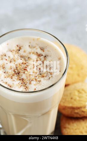 caffè con latte e noce grattugiate in un primo piano di vetro. Caffè Raff. Foto Stock