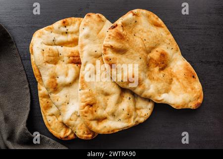 Tre pezzi di naan con una superficie dorata, pronti per essere serviti. Vista dall'alto. Foto Stock