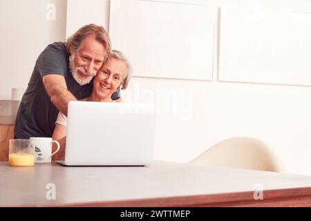 Coppia senior utilizzando portatile a casa Foto Stock