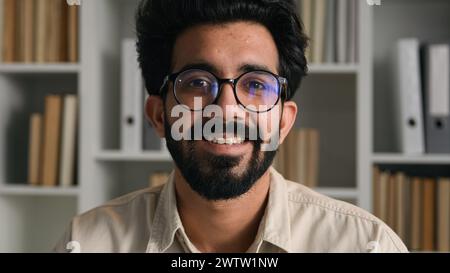 Allegro uomo arabo uomo d'affari insegnante insegnante tutor uomo d'affari ritratto di un ragazzo indiano felice sorriso sincero studente laureato intelligente in occhiali da vista a. Foto Stock