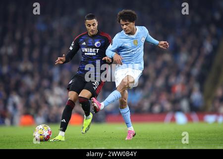 Oscar Bobb del Manchester City e Elias Achouri del Copenhagen durante il turno di UEFA Champions League 16 tra Manchester City e FC Copenhagen all'Etihad Stadium il 6 marzo 2024 a Manchester, Inghilterra. (Foto di Daniel Chesterton/phcimages.com) Foto Stock