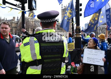 Londra, Inghilterra, Regno Unito. 20 marzo 2024. L'agente di polizia è in guardia mentre i manifestanti pacifici manifestano contro la Brexit e il governo conservatore nella piazza del Parlamento (immagine di credito: © Cal Ford/ZUMA Press Wire) SOLO PER USO EDITORIALE! Non per USO commerciale! Foto Stock