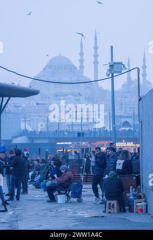 I buliti ripercorrono la loro vita quotidiana in città con la nuova moschea in lontananza Foto Stock