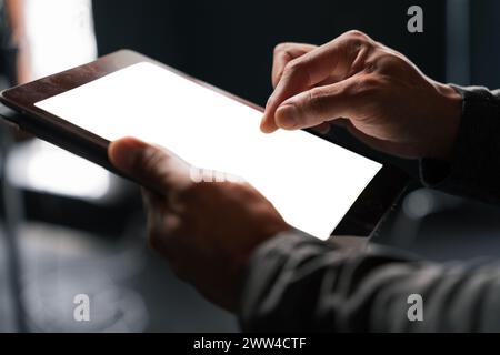 Persona che utilizza un tablet con schermo bianco e gesti delle mani Foto Stock