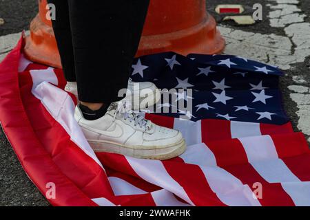 San Juan, Stati Uniti. 22 marzo 2024. Un manifestante si erge sulla bandiera degli Stati Uniti durante una manifestazione per protestare contro la visita del vicepresidente Kamala Harris a Porto Rico a San Juan, Porto Rico, venerdì 22 marzo 2024. (Foto di Carlos Berríos Polanco/Sipa USA) credito: SIPA USA/Alamy Live News Foto Stock