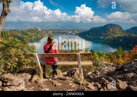 Bled, Slovenia - donna seduta su una panchina che guarda il lago di Bled Foto Stock
