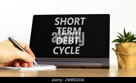 Simbolo del ciclo del debito a breve termine. Concept words ciclo del debito a breve termine su una bellissima tavoletta nera. Splendido sfondo bianco. Mano d'affari. Calcolatrice. Foto Stock