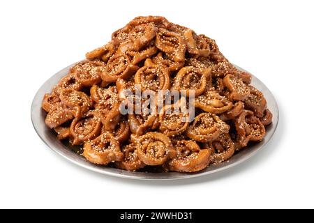 Piatto con tradizionale chebakia marocchina appena sfornata per ramadan isolato su sfondo bianco Foto Stock