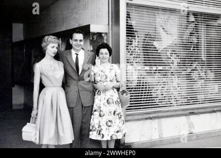 Elegante giovane coppia e amica donna all'aperto appoggiata sul muro sotto l'albero alla fine degli anni '1950 o all'inizio degli anni '1960 in Germania *** elegante giovane coppia e amica donna all'esterno appoggiata sul muro sotto l'albero alla fine degli anni '1950 o all'inizio degli anni '1960 in Germania Foto Stock