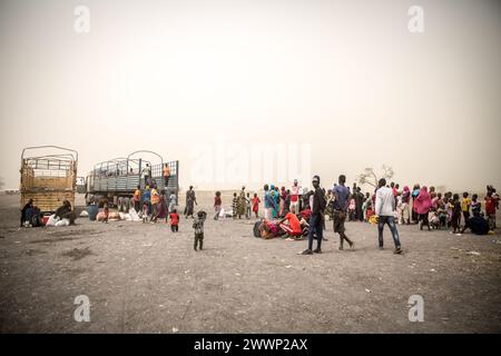 Joda, Sudan del Sud. 20 marzo 2024. Le persone aspettano di essere caricate su camion per portarle da Joda, al confine sudanese, a Renk, nel Sud Sudan, dove rimarranno in un campo di transito prima di essere trasportate nel paese. Circa 1.000 rimpatriati e rifugiati sudanesi attraversano ogni giorno il confine dal Sudan al Sudan meridionale. La guerra in Sudan, iniziata nell'aprile 2023, ha portato alla più grande crisi di sfollamento del mondo. (Foto di Sally Hayden/SOPA Images/Sipa USA) credito: SIPA USA/Alamy Live News Foto Stock