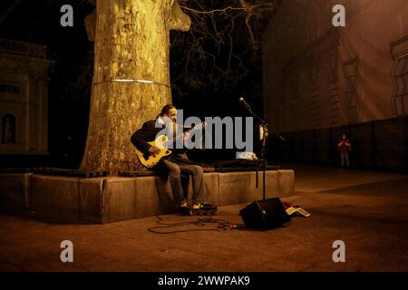 Il musicista di strada suona in Piazza Dumskaya. Un massiccio attacco missilistico contro l'Ucraina avvenne nelle ore mattutine del 22 marzo 2024. Kharkiv, Zaporizhzhia, Kryvyi Rih, Khmelnytskyi, Poltava Oblast, Vinnytsia Oblast, Lviv Oblast, Ivano-Frankivsk Oblast, Mykolaiv Oblast, Odesa Oblast, l'Oblast' di Sumy e altre parti del paese furono sottoposte al fuoco di razzi da parte dell'esercito russo. La stazione idroelettrica Dnieper fu messa fuori servizio (otto missili colpiti; un filobus che trasportava civili che viaggiavano lungo la diga fu colpito; la seconda unità di potenza fu distrutta). Tre persone sono rimaste uccise e altre 14 sono rimaste ferite Foto Stock