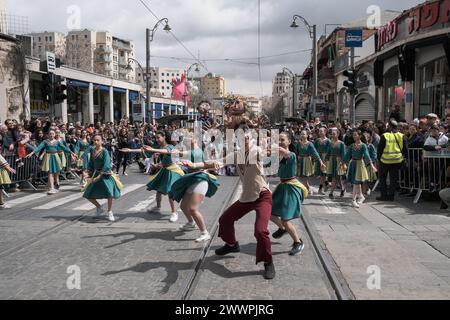 Gerusalemme, Israele. 25 marzo 2024. Gli spettatori in costume sono in fila lungo Jaffa Road nel centro di Gerusalemme per assistere alla Purim Unity Parade. Purim è una delle feste più colorate e popolari dell'Ebraismo, che commemora gli eventi descritti nel Libro di Ester e in particolare la miracolosa salvezza degli ebrei nell'antica Persia. Crediti: NIR Alon/Alamy Live News Foto Stock