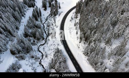 Vista aerea di un paesaggio invernale con una strada curva Foto Stock