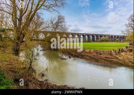 Una vista sul fiume Welland verso lo spettacolare viadotto di Harringworth in una luminosa giornata invernale Foto Stock