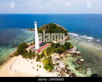 Vista della spiaggia e delle isole di Belitung con il faro dell'isola di Lengkuas. Splendida vista aerea delle isole, delle barche, del mare e delle rocce di Belitung, Indonesia Foto Stock