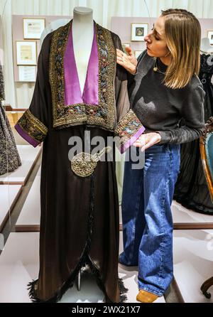 Leighton House, Londra, Regno Unito. 27 marzo 2024. Cappotto da sera di proprietà di Maud, c 1912 con bordo in stile ikat sovrapposto a nastro dorato. Una mostra di abiti rari e significativi a livello nazionale che mette in luce la storia intima di una madre della classe media e della sua figlia benestante in un momento storico che ha plasmato il modo in cui la moda viene consumata oggi.Paul Quezada-Neiman/Alamy Live News crediti: Paul Quezada-Neiman/Alamy Live News Foto Stock