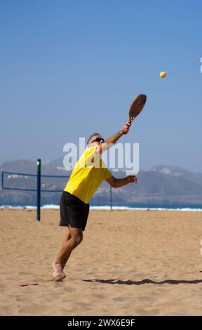Uomo anziano che gioca a Beach tennis Foto Stock