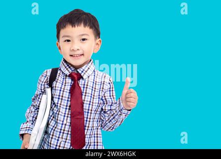 Torna a scuola. Studentessa che mostra i pollici in alto Foto Stock