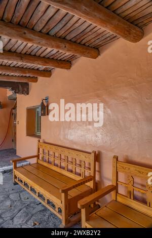 Panchina nel complesso della sede centrale costruita dal CCC in stile revival Pueblo, Bandelier National Monument, New Mexico, USA Foto Stock