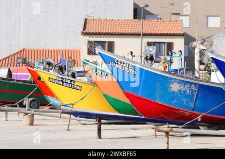 Diverse colorate barche da pesca parcheggiate l'una accanto all'altra su un bacino di carenaggio, Mindelo, Portogallo settentrionale Foto Stock