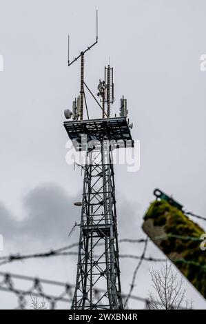 Mobillfunksender auf Sendemast des ehemaligen Warnamtes Meinerzhagen IM Zuge der Auflösung im Jahre 1997 wurde auch das Warnamt Meinerzhagen Märkischer Kreis, Sauerland stillgelegt. Auf dem Anwesen sind mittlerweile Privatfirmen angesiedelt. Der Sendemast wird weiter artgerecht genutzt und beherbergt Richtfunkstrecken und Mobilfunkantennen. DAS Gelände ist noch immer gut gesichert: Aufgrund der Funktion der Warnämter während des Kalten Krieges ist die Liegenschaft ähnlich wie eine Kaserne oder eine Grenzanlage gesichert: MIT Stacheldraht und hohen Zäunen. für Unbefugte ist das Grundstück noch Foto Stock