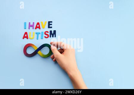 Le mani autistiche dei ragazzi e l'arcobaleno otto simbolo dell'infinito. Simbolo del giorno di consapevolezza dell'autismo. Foto Stock