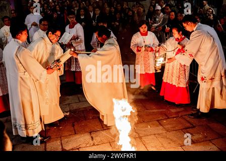 Barcellona, Spagna.30 marzo 2024, Barcellona, Spagna: In questo sabato Santo i membri della comunità filippina di Barcellona accendono la candela pasquale durante il solenne rituale della Veglia Pasquale e la benedizione del nuovo fuoco presso la Chiesa di Sant Agusti nel quartiere Raval nell'ambito delle celebrazioni della settimana Santa. Crediti: Jordi Boixareu/Alamy Live News Foto Stock