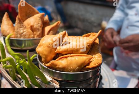 Samosas fritte con ripieno di verdure, popolari spuntini indiani venduti in un mercato di strada. Spuntini per le strade, spuntini di patate Samosa, samsa vegetariana Foto Stock