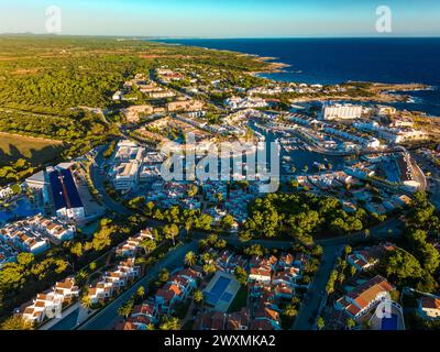 Vista aerea del porto, delle abitazioni e della spiaggia di Cala en Bosc sull'isola spagnola di Minorca. Foto Stock