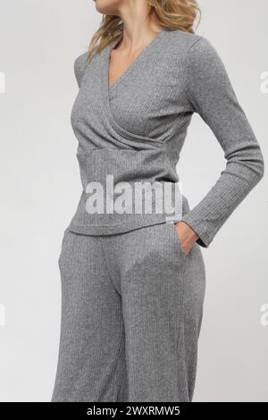 Serie di foto in studio della modella femminile in maglia grigia, collezione moda autunno inverno. Foto Stock
