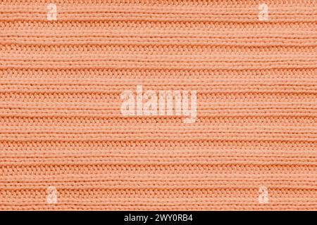 Fondo tessile Jersey , tessuto a righe arancioni. Maglieria di lana, maglione, superficie del pullover, struttura tessile, superficie in tessuto, weavi Foto Stock
